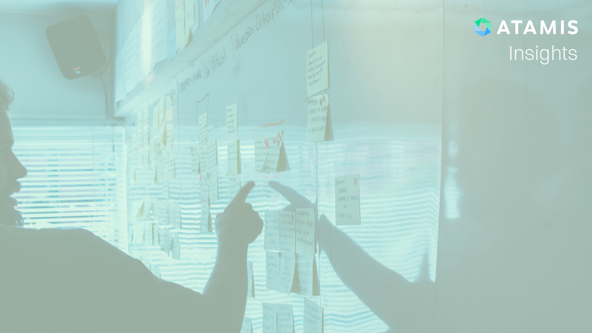A man presenting points at white board.